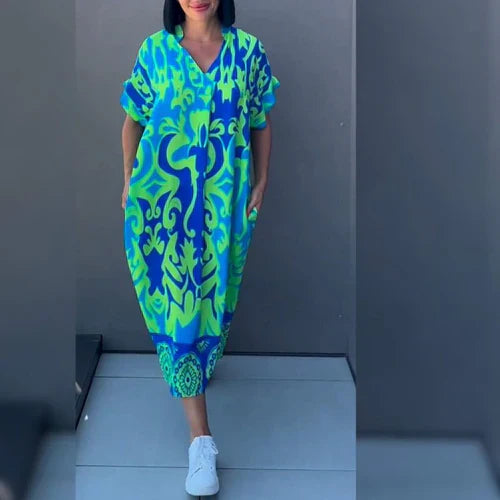 Elena™ | Blommig och elegant klänning med svepande siluett
